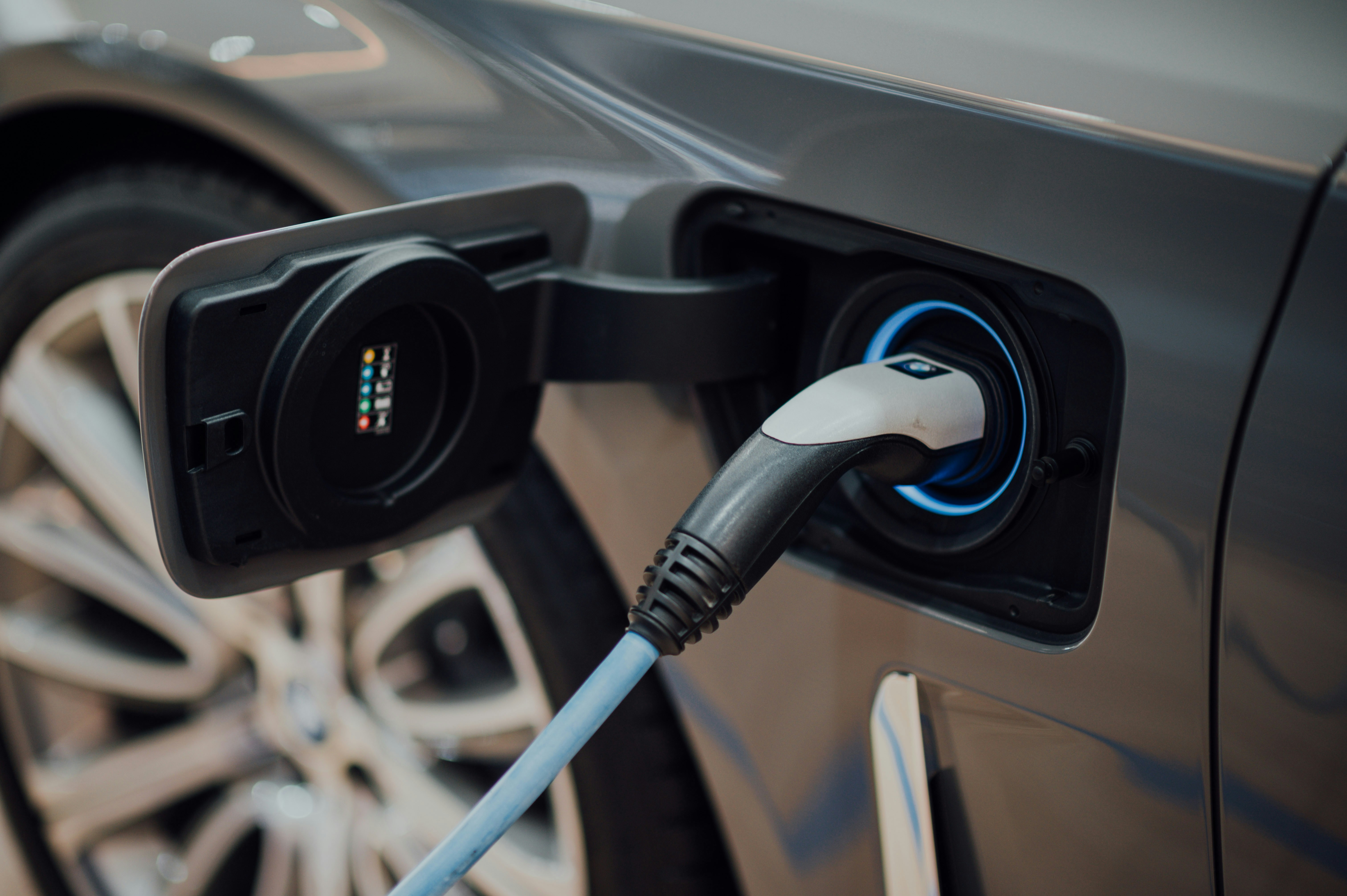 Electric vehicle charging port — representing the shift toward zero-emission fleet vehicles in Canada