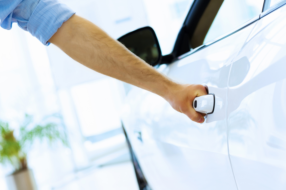 Close up human hand opening car door