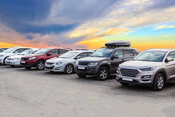 Selection of silver, white, and red compact SUVs parked in a professional vehicle inventory lot.